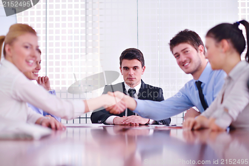 Image of business people making a deal at meeting