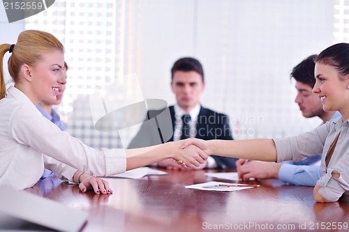 Image of business people making a deal at meeting
