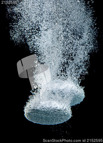 Image of Effervescent tablet in water with bubbles