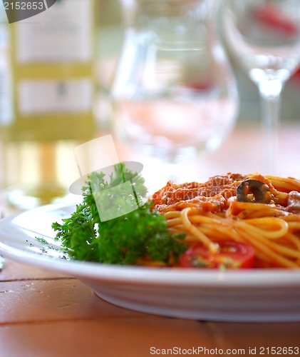 Image of Spaghetti with a tomato sauce on a table in cafe