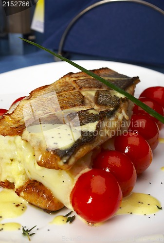 Image of Fish with tomatoes and a potato