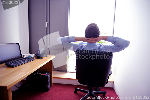 Image of happy young business man at office