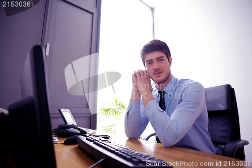 Image of happy young business man at office