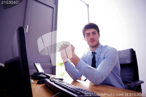 Image of happy young business man at office