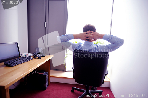 Image of happy young business man at office