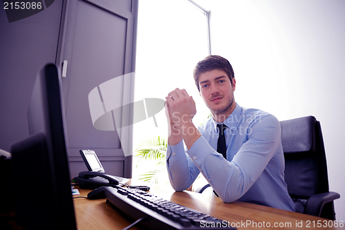 Image of happy young business man at office