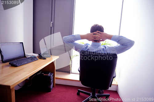 Image of happy young business man at office