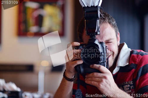 Image of happy young business man at office