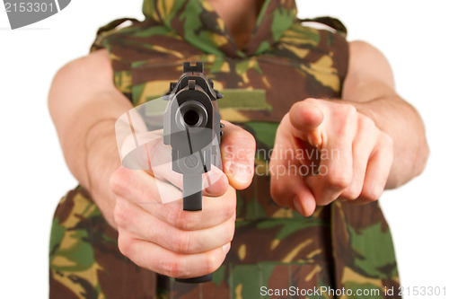 Image of Soldier in camouflage vest is holding a gun