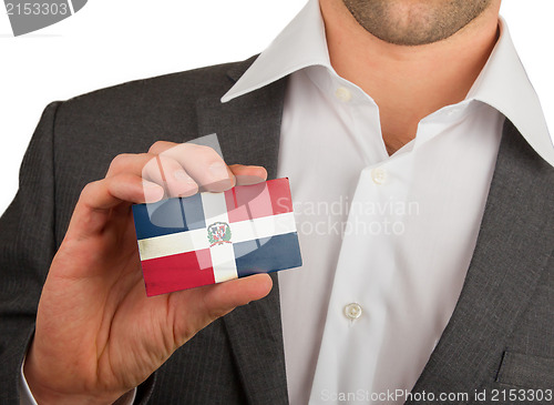 Image of Businessman is holding a business card, The Dominican Republic