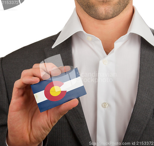 Image of Businessman is holding a business card, Colorado