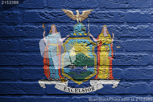 Image of Brick wall with a painting of a flag, New York