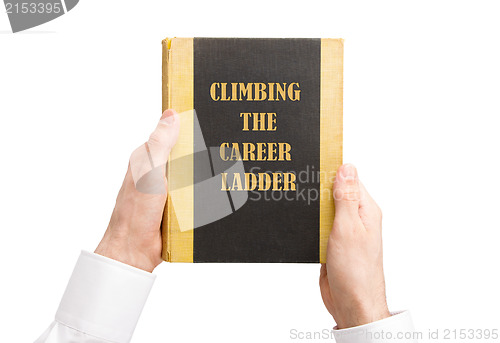 Image of Businessman holding an old book