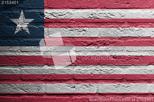 Image of Brick wall with a painting of a flag, Liberia