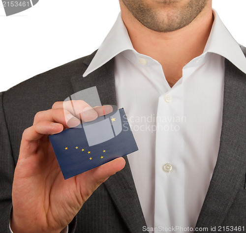 Image of Businessman is holding a business card, Alaska