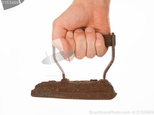 Image of Hand holding an old iron, isolated