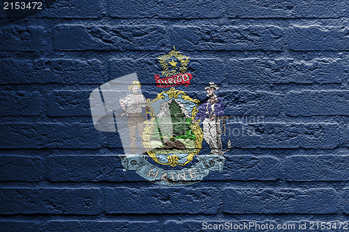 Image of Brick wall with a painting of a flag, Maine