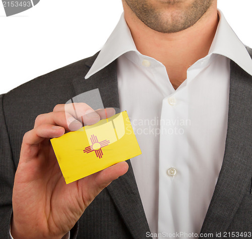 Image of Businessman is holding a business card, New Mexico