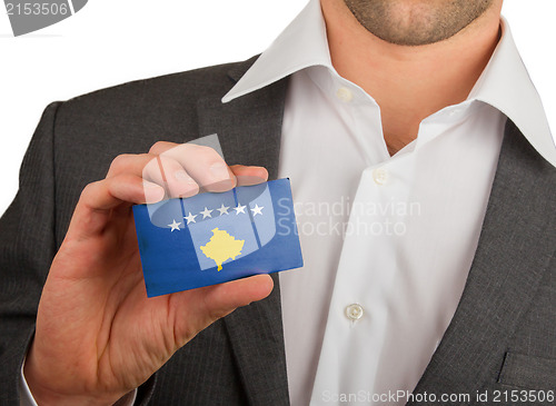 Image of Businessman is holding a business card, Kosovo