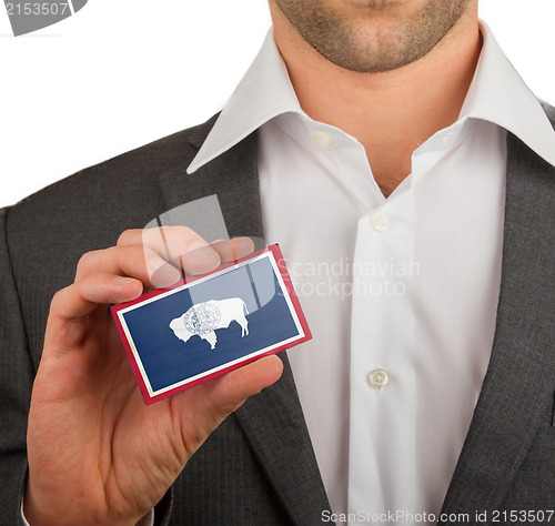 Image of Businessman is holding a business card, Wyoming