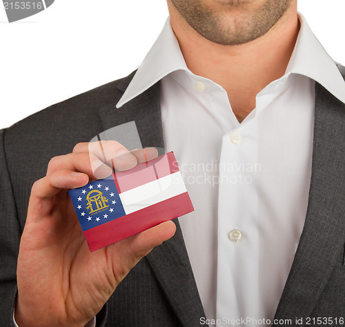 Image of Businessman is holding a business card, Georgia