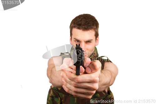 Image of Soldier in camouflage vest is holding a gun