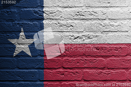 Image of Brick wall with a painting of a flag, Texas