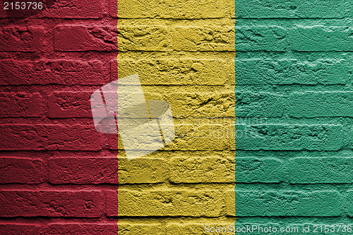 Image of Brick wall with a painting of a flag, Guinea