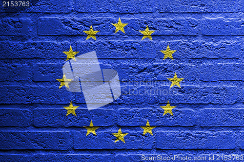 Image of Brick wall with a painting of a flag