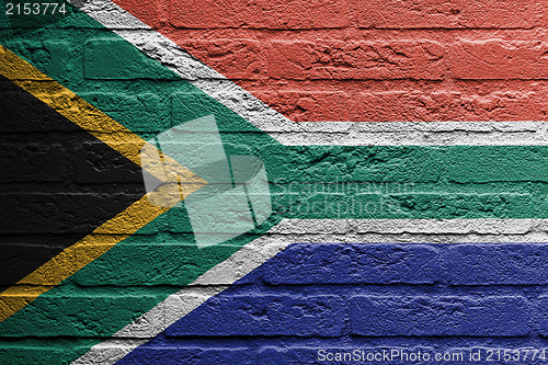 Image of Brick wall with a painting of a flag