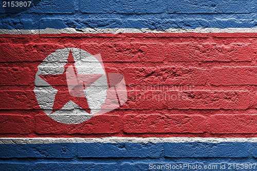 Image of Brick wall with a painting of a flag, North Korea