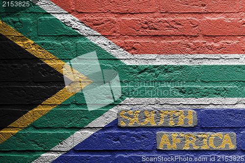Image of Brick wall with a painting of a flag