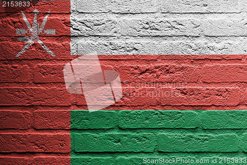 Image of Brick wall with a painting of a flag, Oman