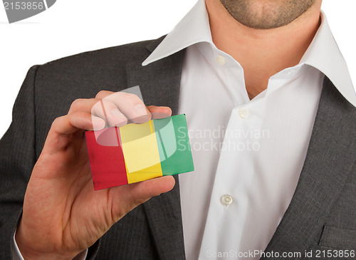 Image of Businessman is holding a business card, Guinea