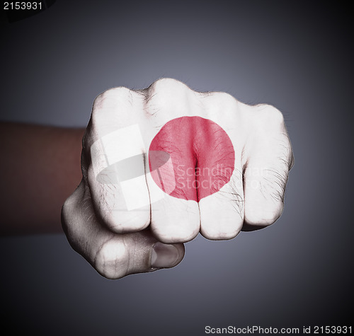 Image of Front view of punching fist on gray background