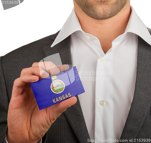 Image of Businessman is holding a business card, Kansas