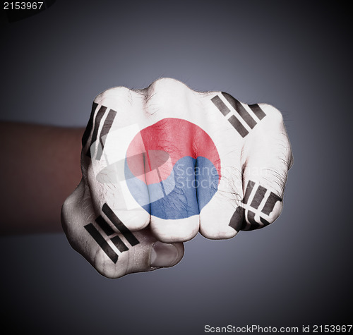 Image of Front view of punching fist on gray background