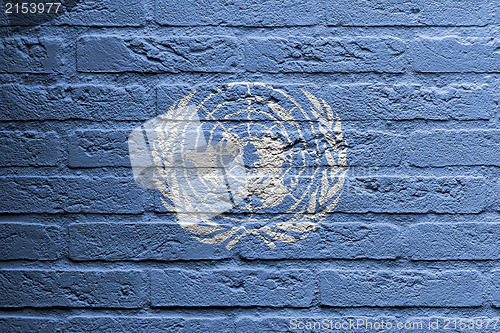Image of Brick wall with a painting of a flag, UN
