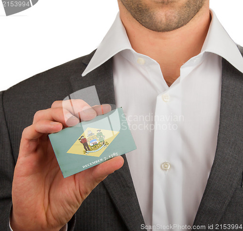 Image of Businessman is holding a business card, Delaware