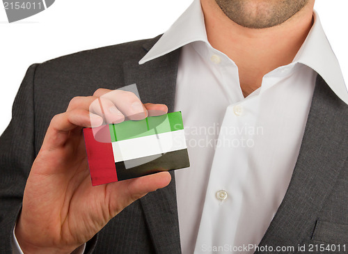 Image of Businessman is holding a business card, UAE