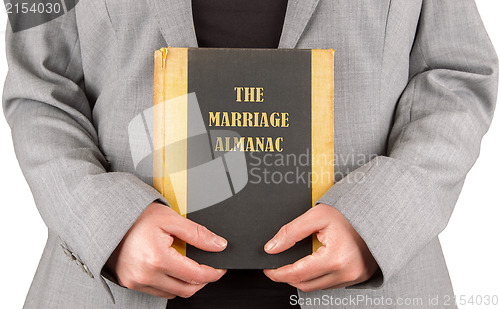 Image of Woman holding a marriage almanac