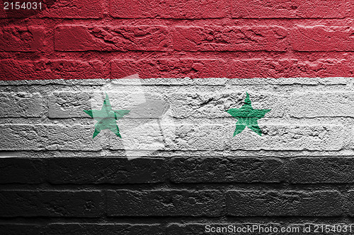 Image of Brick wall with a painting of a flag, Syria