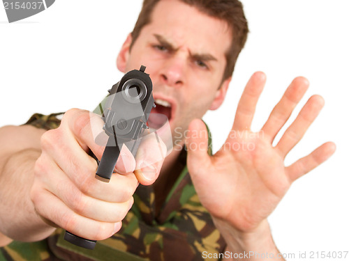 Image of Soldier in camouflage vest is holding a gun