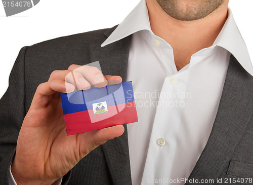 Image of Businessman is holding a business card, Haiti