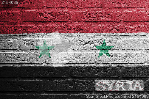 Image of Brick wall with a painting of a flag, Syria