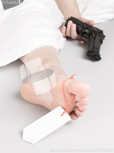 Image of Woman committed suicide, under a sheet with a toe tag