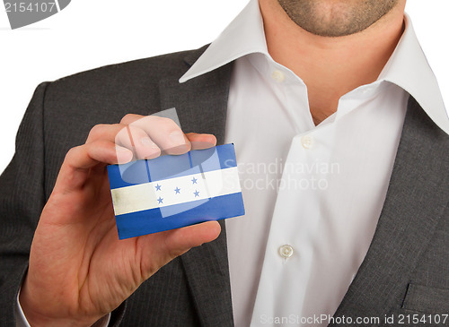 Image of Businessman is holding a business card, Honduras
