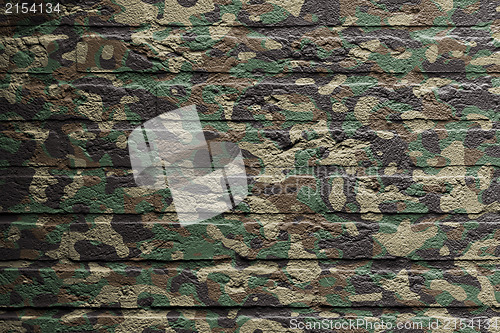 Image of Brick wall with a painting of a flag, Camouflage