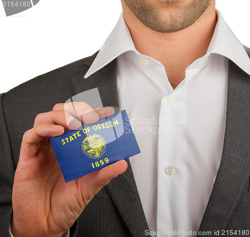 Image of Businessman is holding a business card, Oregon