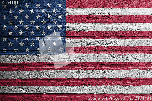 Image of Brick wall with a painting of a flag, USA